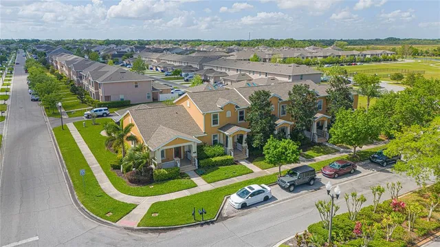 an aerial view of a house with a garden and lake view