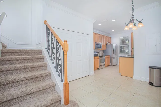 a view of a kitchen with furniture and an empty room
