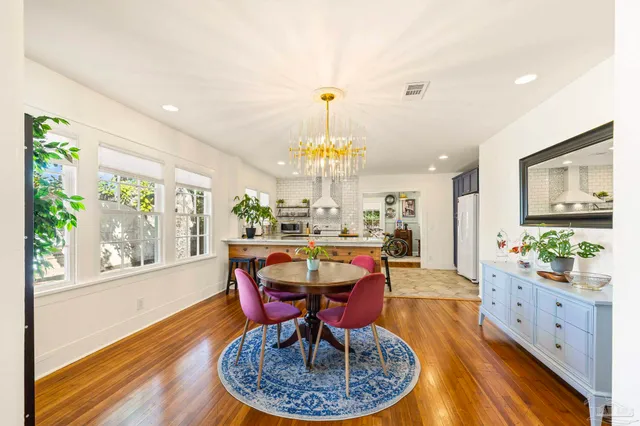 a dining room with furniture a rug and wooden floor