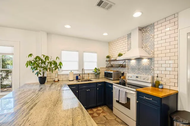 a kitchen with a sink stove and cabinets