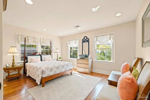 a bedroom with a bed and glass window