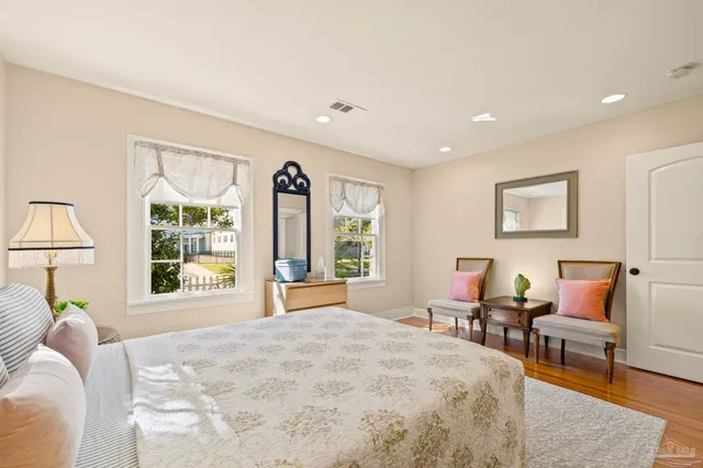 a bedroom with a bed and a large window