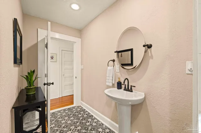 a bathroom with a sink a mirror and a shower