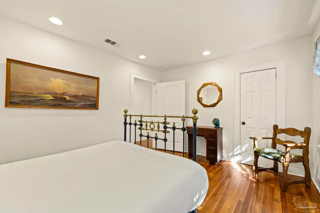 a bed room with a bed and chair