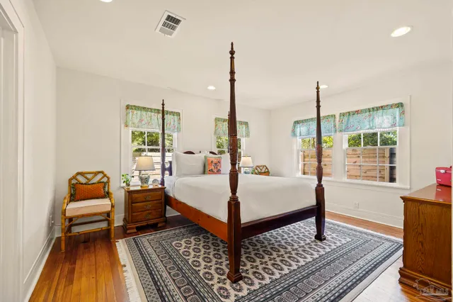 a bed sitting in a bedroom next to a window