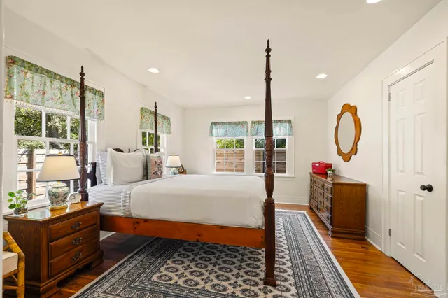 a bed room with a bed mirror and a window