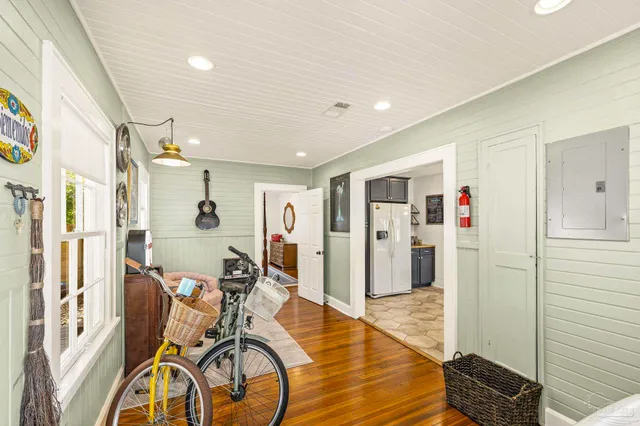 a view of a hallway with furniture and a chandelier