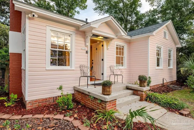 a front view of house with yard outdoor seating and green space