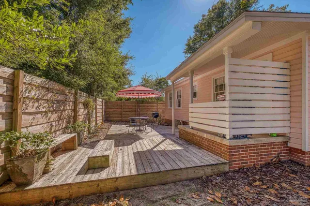 a view of a house with backyard and sitting area