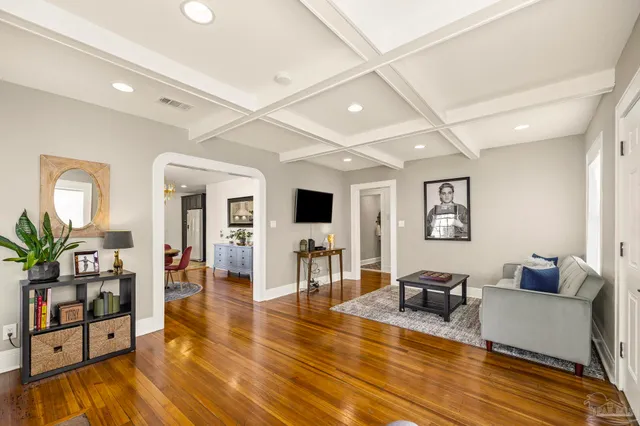 a living room with furniture and wooden floor