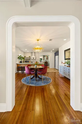 a living room with dining room and wooden floor