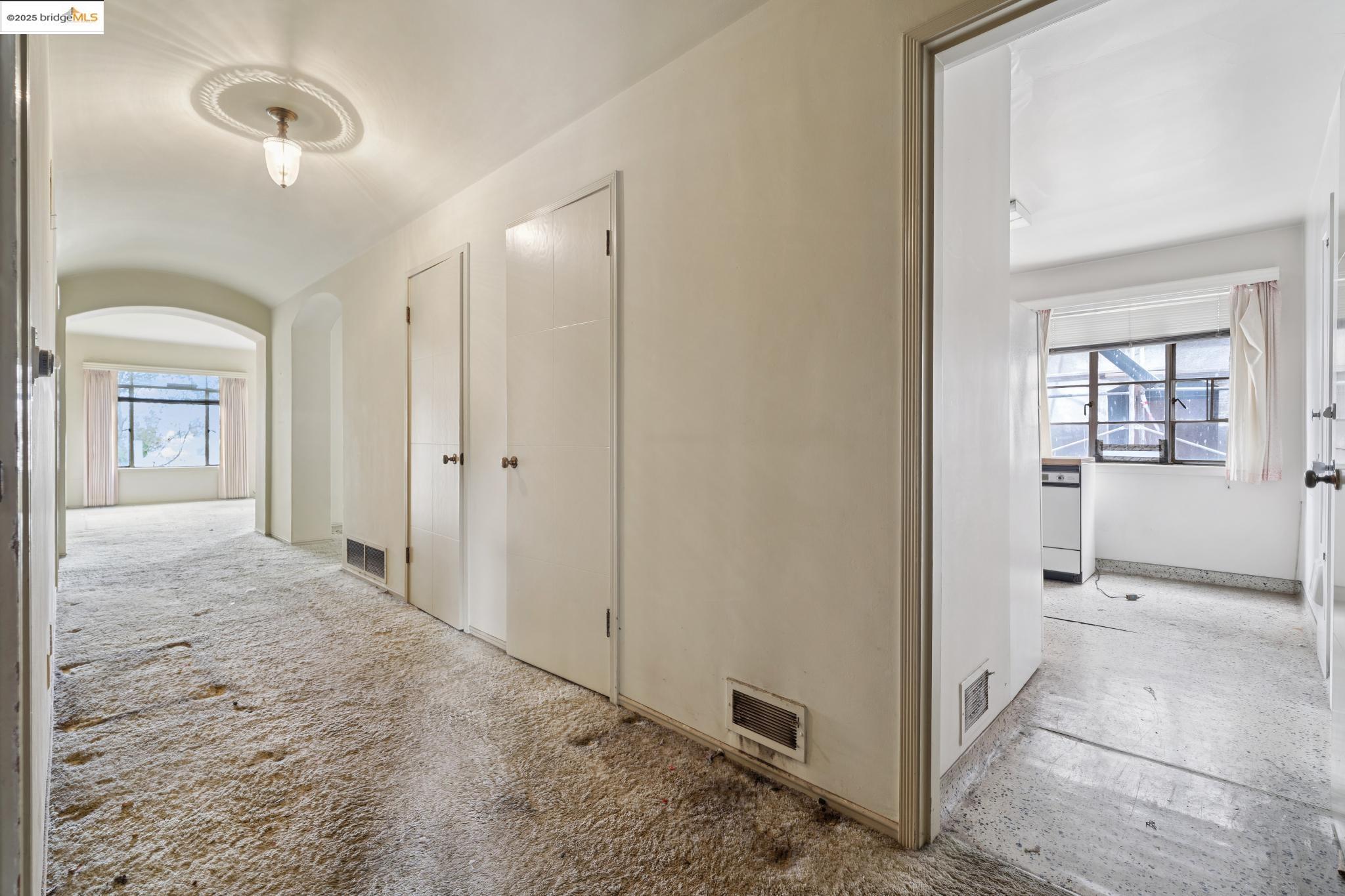 521 Merritt Avenue Oakland, CA 94610 - Photo 19 of 27 a view of a hallway with wooden floor and a living room