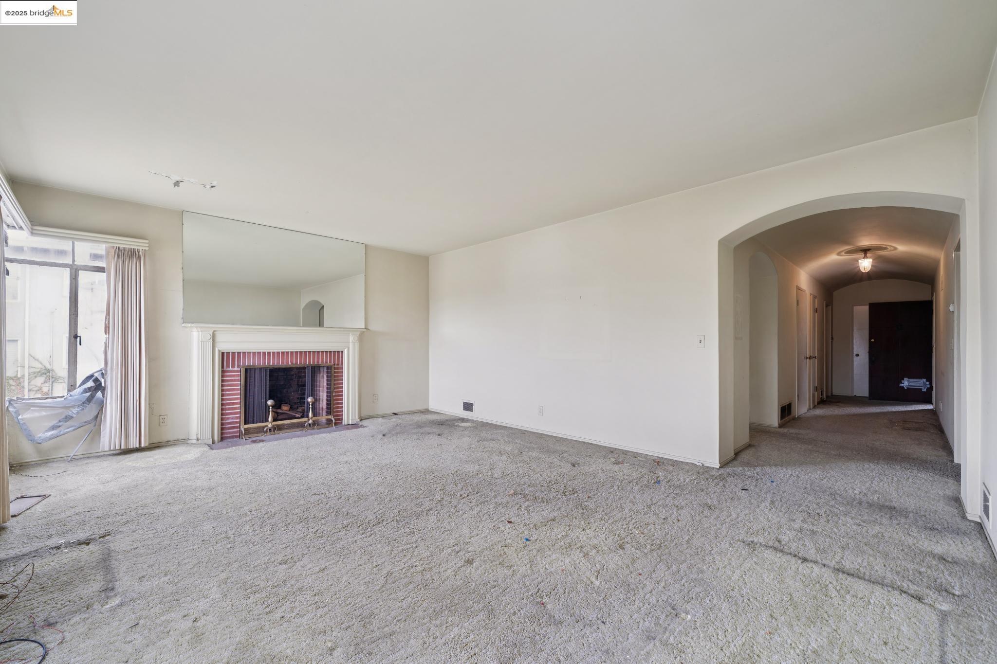 521 Merritt Avenue Oakland, CA 94610 - Photo 21 of 27 an empty room with fireplace and windows