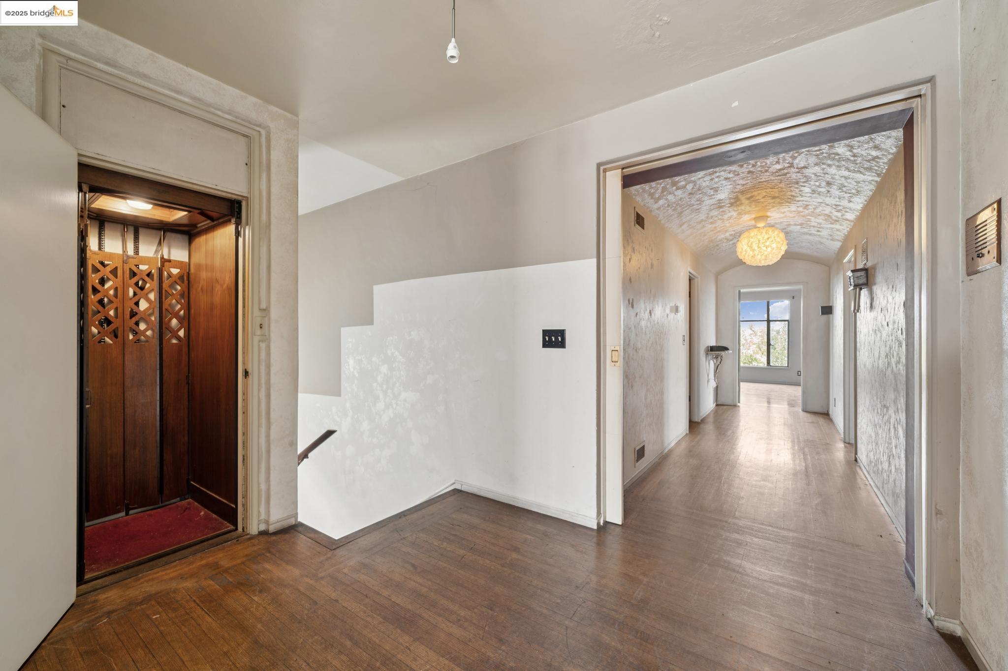 521 Merritt Avenue Oakland, CA 94610 - Photo 6 of 27 a view of a hallway with wooden floor and glass door