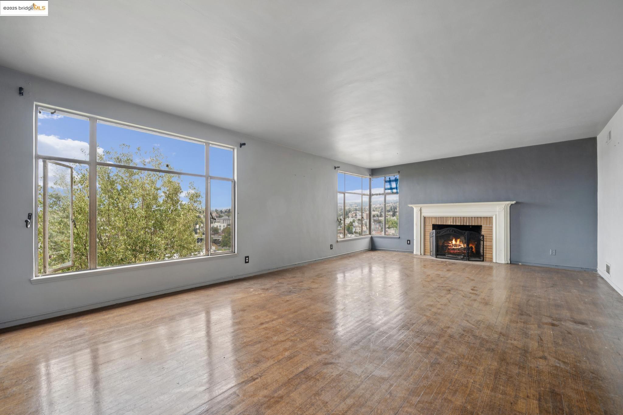 521 Merritt Avenue Oakland, CA 94610 - Photo 8 of 27 a view of an empty room with a window and a fireplace