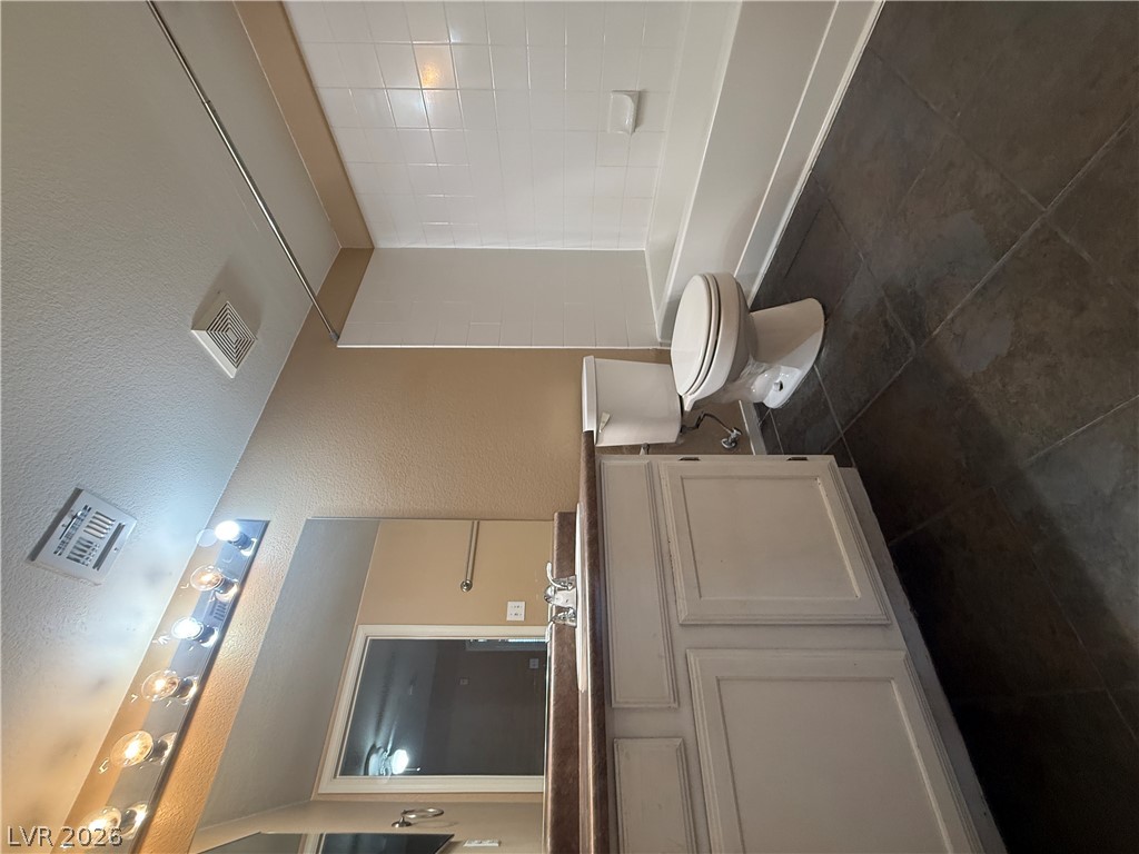 7255 West Sunset Road, Unit 2052 Las Vegas, NV 89113 - Photo 15 of 16 A well-appointed bathroom features a single vanity, a toilet, and a combined shower-tub unit.
