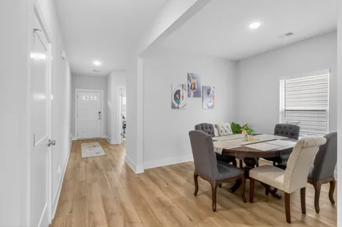 a view of a dining room with furniture and wooden floor