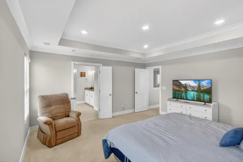 a bedroom with furniture and a flat screen tv