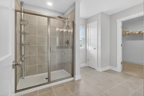 a bathroom with a glass shower door