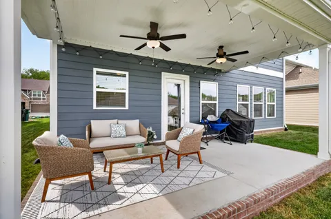 a view of a patio with table and chairs