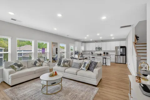 a living room with furniture and a wooden floor