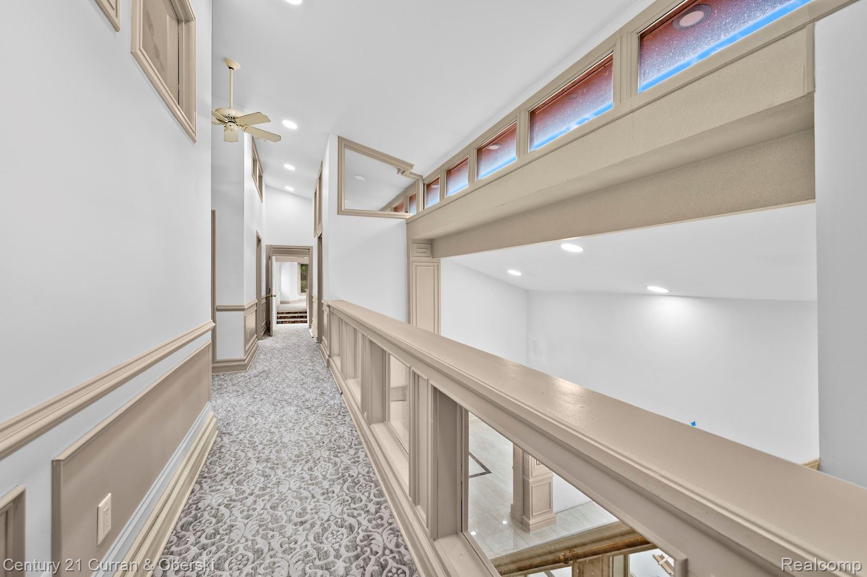 8785 Warren Road Plymouth, MI 48170 - Photo 20 of 46 Upper-level hallway with decorative wainscoting and patterned carpet flooring