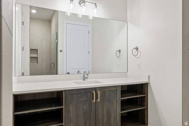 684 West High Tide Place, Unit 131 St. George, UT 84790 - Photo 5 of 27 Bathroom vanity with a rectangular undermount sink, a chrome faucet, and a light-colored countertop
