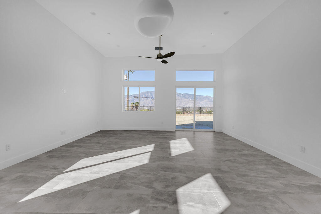 66751 San Felipe Road Desert Hot Springs, CA 92240 - Photo 16 of 59 an empty room with windows and ceiling fan