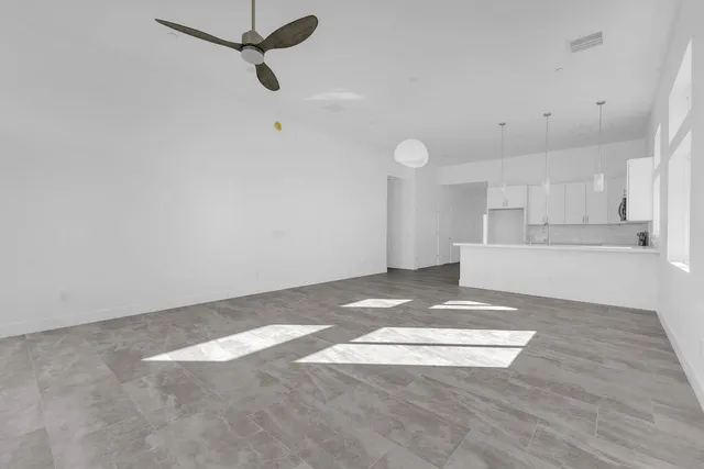 an empty room with a ceiling fan