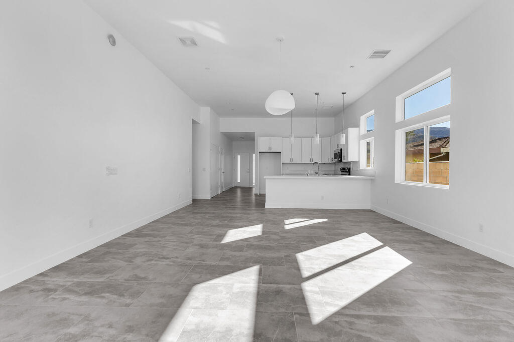 66751 San Felipe Road Desert Hot Springs, CA 92240 - Photo 20 of 59 a large kitchen with kitchen island a sink stainless steel appliances and cabinets