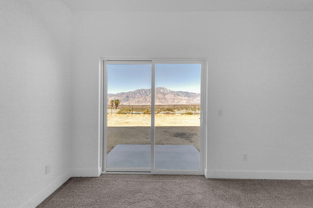 66751 San Felipe Road Desert Hot Springs, CA 92240 - Photo 25 of 59 an empty room with glass door and two windows