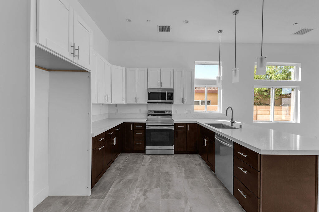 66751 San Felipe Road Desert Hot Springs, CA 92240 - Photo 7 of 59 a large kitchen with stainless steel appliances granite countertop a sink a stove and a refrigerator