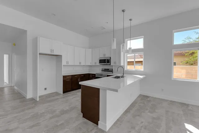 a kitchen with a sink stove and microwave