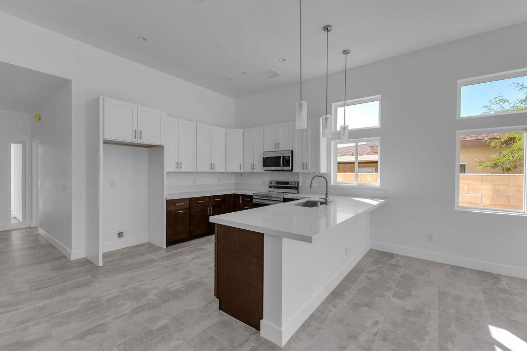 66751 San Felipe Road Desert Hot Springs, CA 92240 - Photo 8 of 59 a kitchen with a sink stove and refrigerator