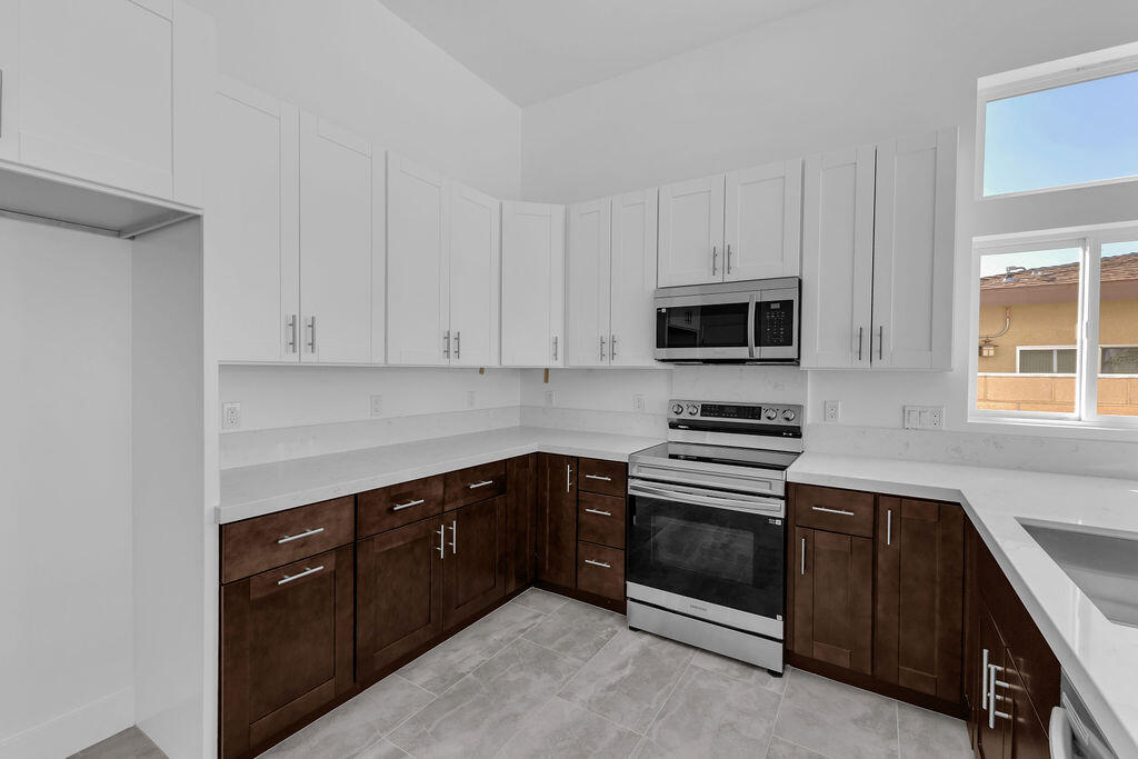 66751 San Felipe Road Desert Hot Springs, CA 92240 - Photo 10 of 59 a kitchen with granite countertop cabinets stainless steel appliances and a window