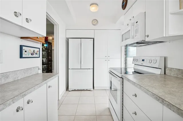 a kitchen with stainless steel appliances granite countertop a refrigerator and a stove
