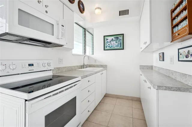 a kitchen with stainless steel appliances granite countertop a sink and a stove