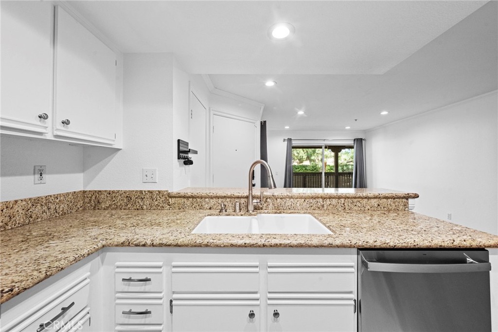 215 South Cross Creek Road, Unit L Orange, CA 92869 - Photo 11 of 50 a kitchen with granite countertop kitchen island a sink appliances and a counter top