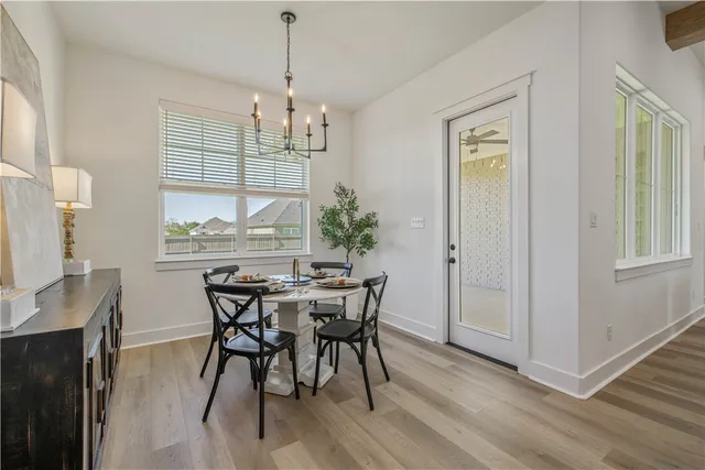 a kitchen with stainless steel appliances granite countertop a sink a stove and a wooden floors