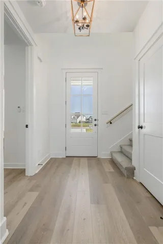 a living room with furniture a chandelier and a large window