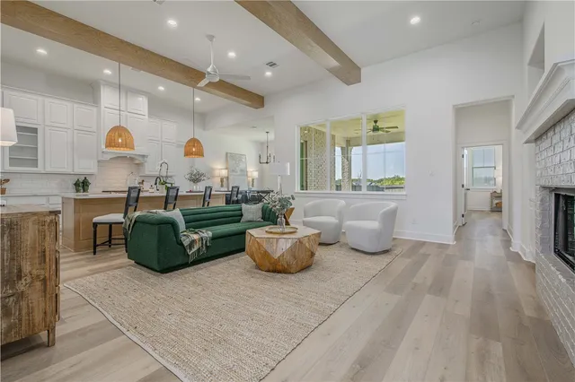 a living room with fireplace furniture and a wooden floor