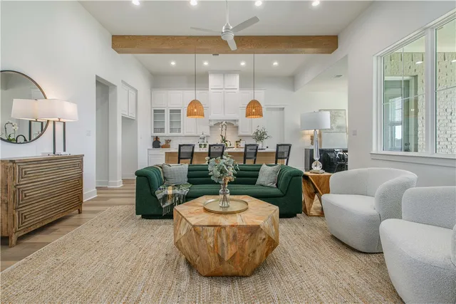 a living room with furniture a fireplace and a table
