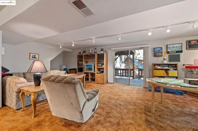 a living room with furniture a projector and flat screen tv