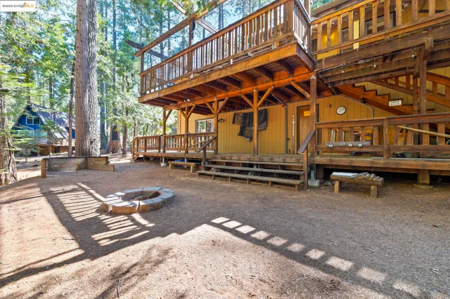 a view of a patio with a table and chairs under an umbrella