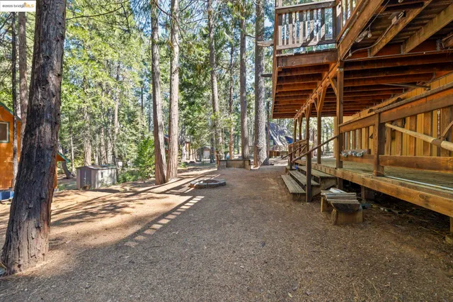 a backyard of a house with barbeque oven table and chairs