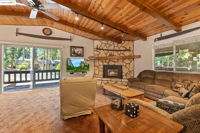 a living room with furniture a fireplace and a table