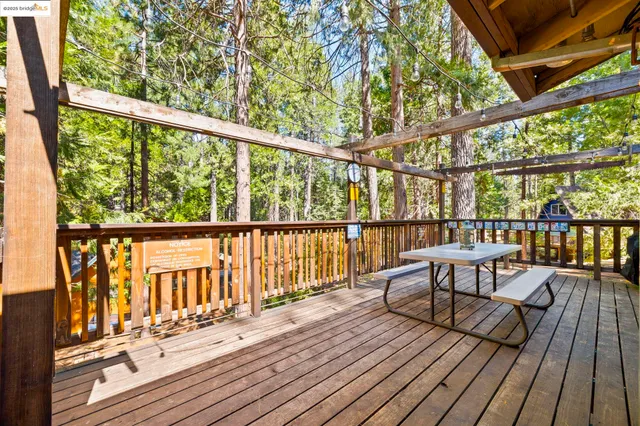 a view of balcony with wooden floor and iron stairs