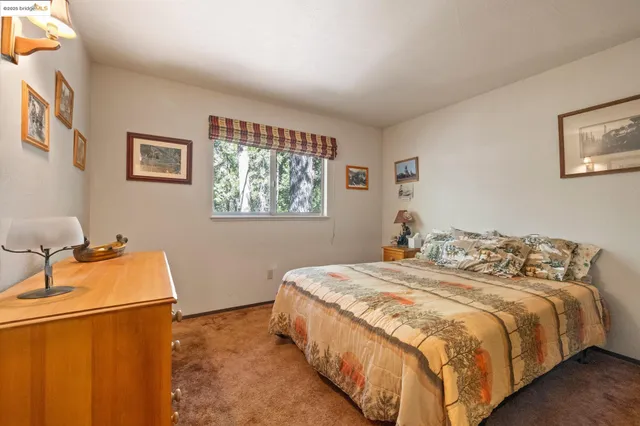 a spacious bedroom with a bed and a cabinets