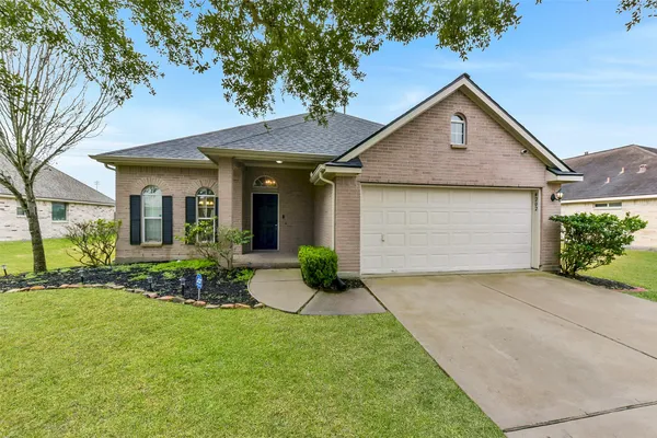a front view of a house with yard and outdoor seating