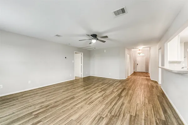 a view of a livingroom with a ceiling fan and window